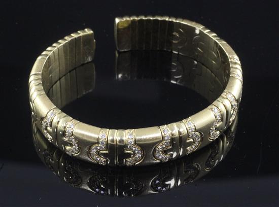 An 18ct gold and diamond open bangle,